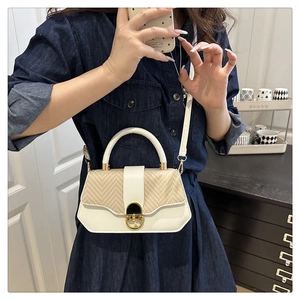 Fashionable woven patchwork hard shell box bag shown on model with shoulder strap