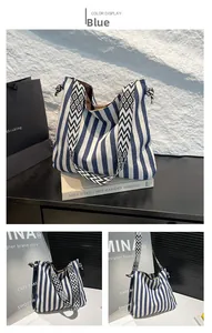 Detail der blau gestreiften Canvas-Tasche mit schwarz-weißem geometrischem Schultergurt