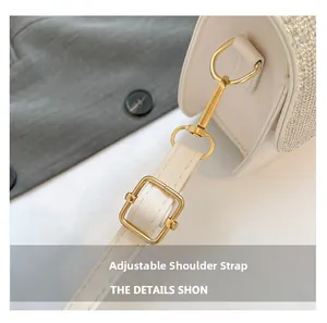 Detail of adjustable leather strap with gold hardware and rhinestones on white bag