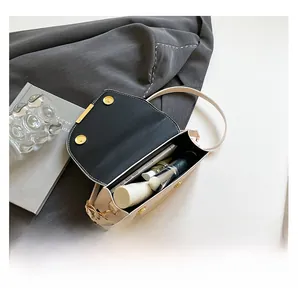 Detail view of cream crossbody bag interior showing storage for phone and lipstick