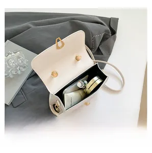 Internal capacity of minimalist crossbody bag holding phone, lipstick and cosmetics