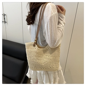 Détail du sac de plage en crochet montrant la maille et les anses en cuir marron