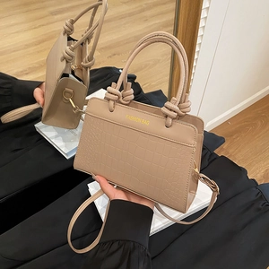 Latte crocodile pattern crossbody bag with knotted handles and fashion logo on the front