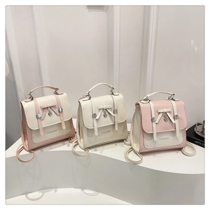 Minimalist school style backpacks in pink and white with heart pendants and bows