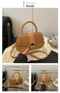 Detail of khaki patchwork crossbody bag with woven flap and golden circular lock