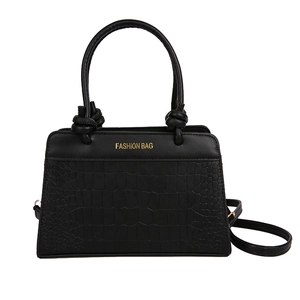 Elegant black crocodile pattern saddle handbag with top handles and adjustable strap