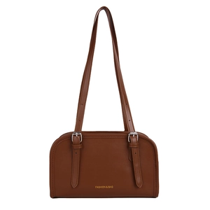 Minimalist brown matte leather shoulder bag with decorative buckle straps and gold text