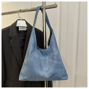 Detailed view of Morandi blue suede tote bag showing minimalist stitching and texture