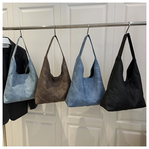 Large hobo tote bags displayed in light blue, dark blue, caramel brown, and classic black
