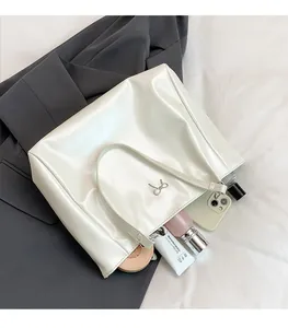 Macro shot of white glossy tote bag interior showing spacious capacity for daily items