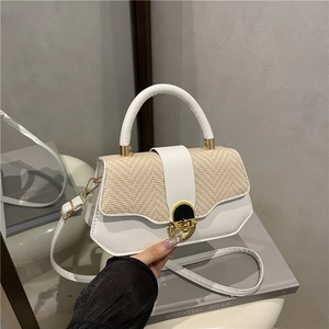 Minimalist straw and leather patchwork handbag with gold metal clasp for summer