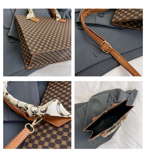 Detail of vintage tote bag featuring clover monogram pattern and silk scarf handle wrap