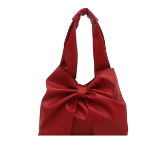 Fashionable red soft PU leather tote bag featuring a large bow knot decorative design