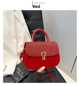 Detail of red sequined flap handbag with gold horseshoe buckle and leather strap