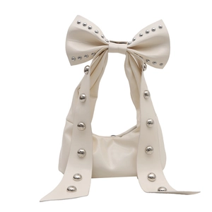 Chic cream bow handbag with silver rivets and unique half-moon silhouette for women