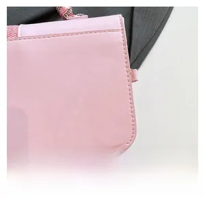 Macro detail of the premium pink faux leather texture and precise edge stitching