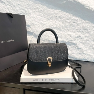 Minimalist black leather crossbody bag with sparkling silver glitter flap and gold buckle