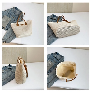 Detail view of large straw tote bag featuring brown leather straps and zip closure