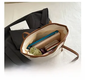 Detail view of large tote bag interior capacity showing storage for tablet and umbrella
