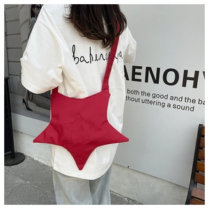 Detail of red star-shaped crossbody bag with star quilting and nylon texture