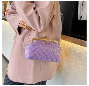 Detail of purple sequin chain bag with shimmering fish scale pattern and metal handle