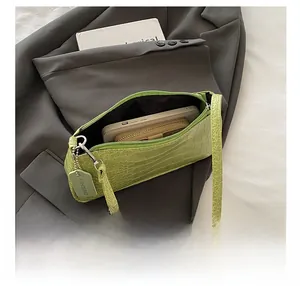 Lime green crocodile pattern baguette bag showing spacious interior with phone and wallet