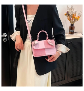 Detailed side view of pink contrast crossbody bag with floral scarf handle and gold hardware