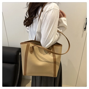 Close-up of beige and brown contrast tote bag showing high-quality textured PU leather