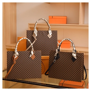 Detail of checkered tote bags with decorative silk scarf handles and leather straps