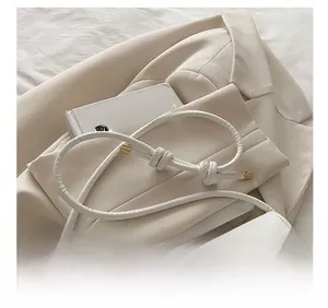 Detail of cream white handbag with piano key pattern and I LIKE MUSIC gold lettering
