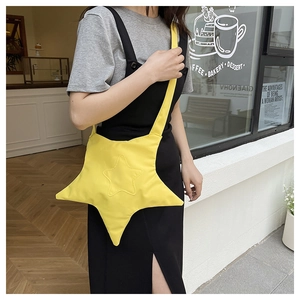 Star-shaped yellow nylon crossbody bag shown on model in a casual lifestyle setting
