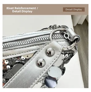 Detail of silver sequin handbag showing rivet reinforcement and metallic chain strap