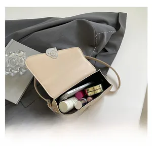 Interior view of beige faux leather shoulder bag showing large capacity for essentials
