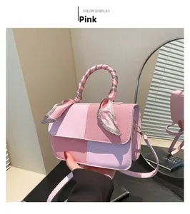 Detail of pink vintage square bag featuring contrast leather and woven fabric texture