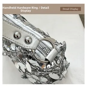 Macro shot of silver sequin bag featuring metal rings and rivet leather handle details