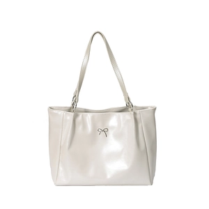Glossy cream shoulder tote bag with silver bow detail and reflective finish