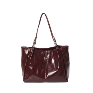 Burgundy red glossy leather tote bag with silver bow accent and slim shoulder straps