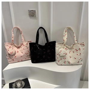 Detailed corduroy texture and cherry print on tote bags with matching round coin purses