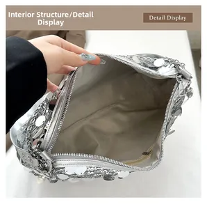 Detail of silver sequin bag showing grey fabric lining and internal zipper pocket