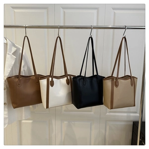 Minimalist faux leather tote bags in four colors hanging on a rack for daily commute