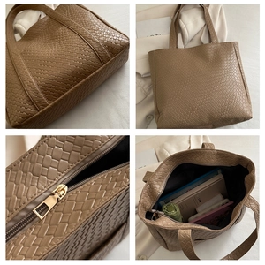 Macro detail of khaki woven texture tote bag featuring metallic zipper and spacious interior