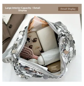 Internal view of silver sequin crescent bag showing large capacity for phone and accessories