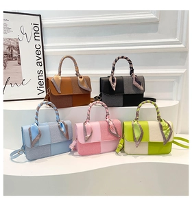 Close-up of five stylish contrast handbags with silk scarf-wrapped handles in various colors