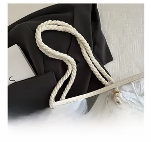 Detailed view of the thick hemp rope handle and reinforced gold grommets on PVC tote
