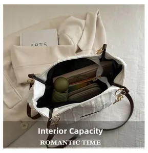Interior view of large white tweed tote bag showing capacity for umbrella and wallet