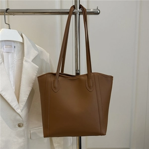 Large brown contrast tote bag with long double straps and vertical stitching detail