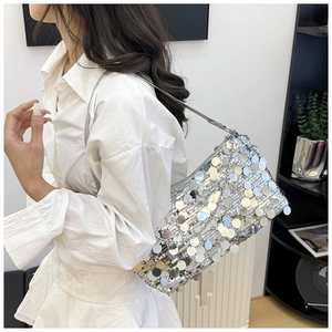 Detail of silver sequin shoulder bag on model with large round metallic texture sequins