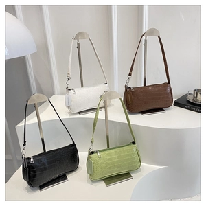 Crocodile pattern baguette bags in four colors displayed on white stairs stand