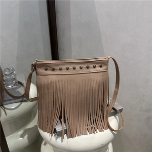 French retro beige leather bucket bag with fringe tassels and metal rivet details