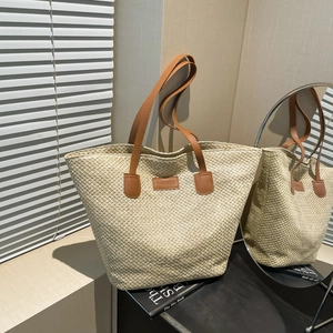 Retro beige woven tote bag with brown faux leather handles for summer beach vacations